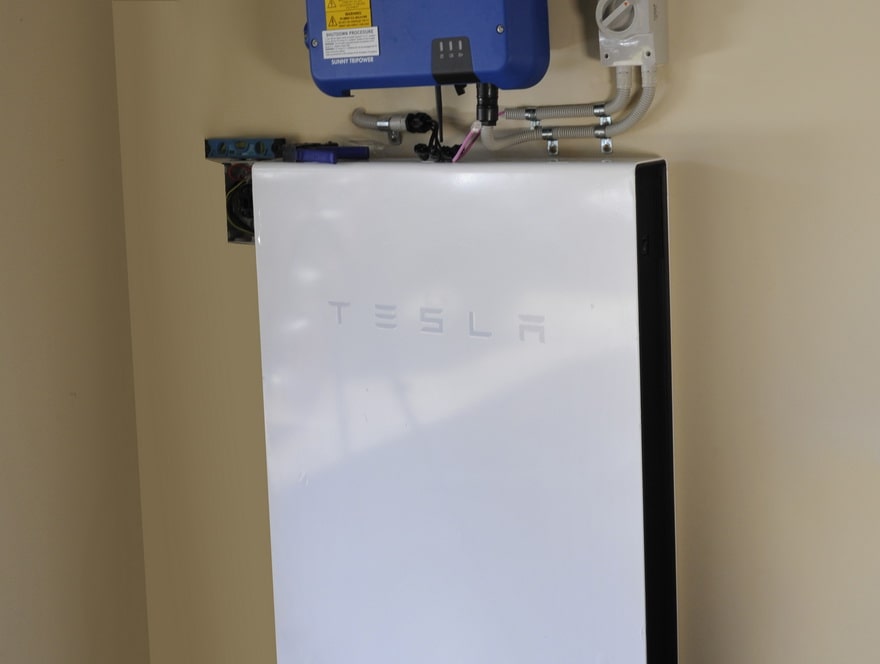 Tesla lithium battery hanging on a wall