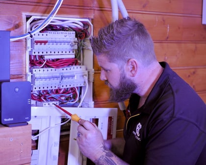 expert electrical employee doing an inspection of a junction box