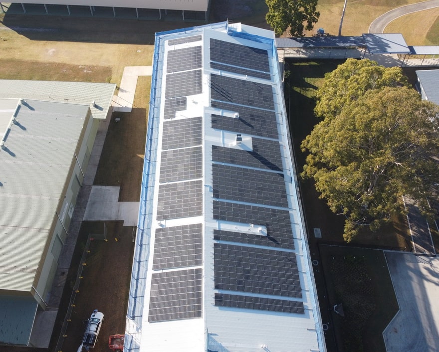 Big commercial building roof completely covered in solar panels