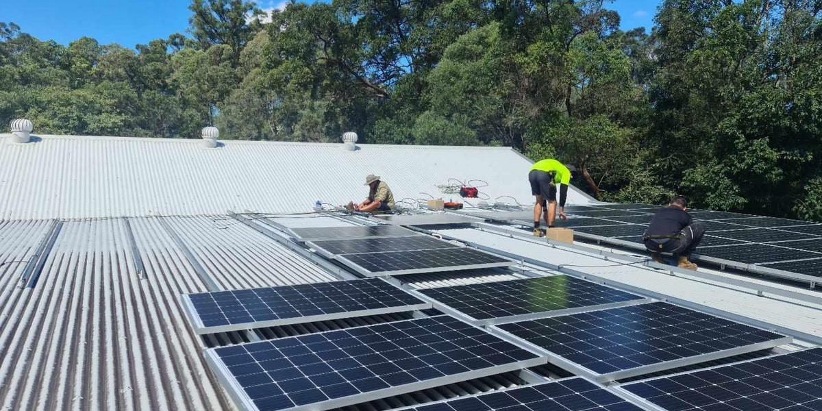 people installing solar panels on roof