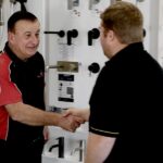 Expert Electrical employee shaking hands with Bathroom Biz Owner